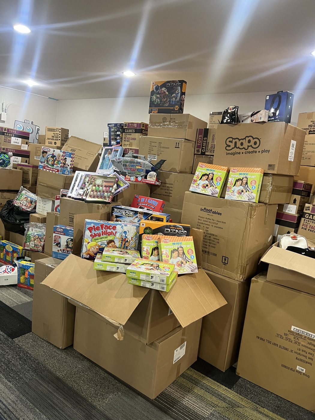 Stacks of donated toys and games ready for families